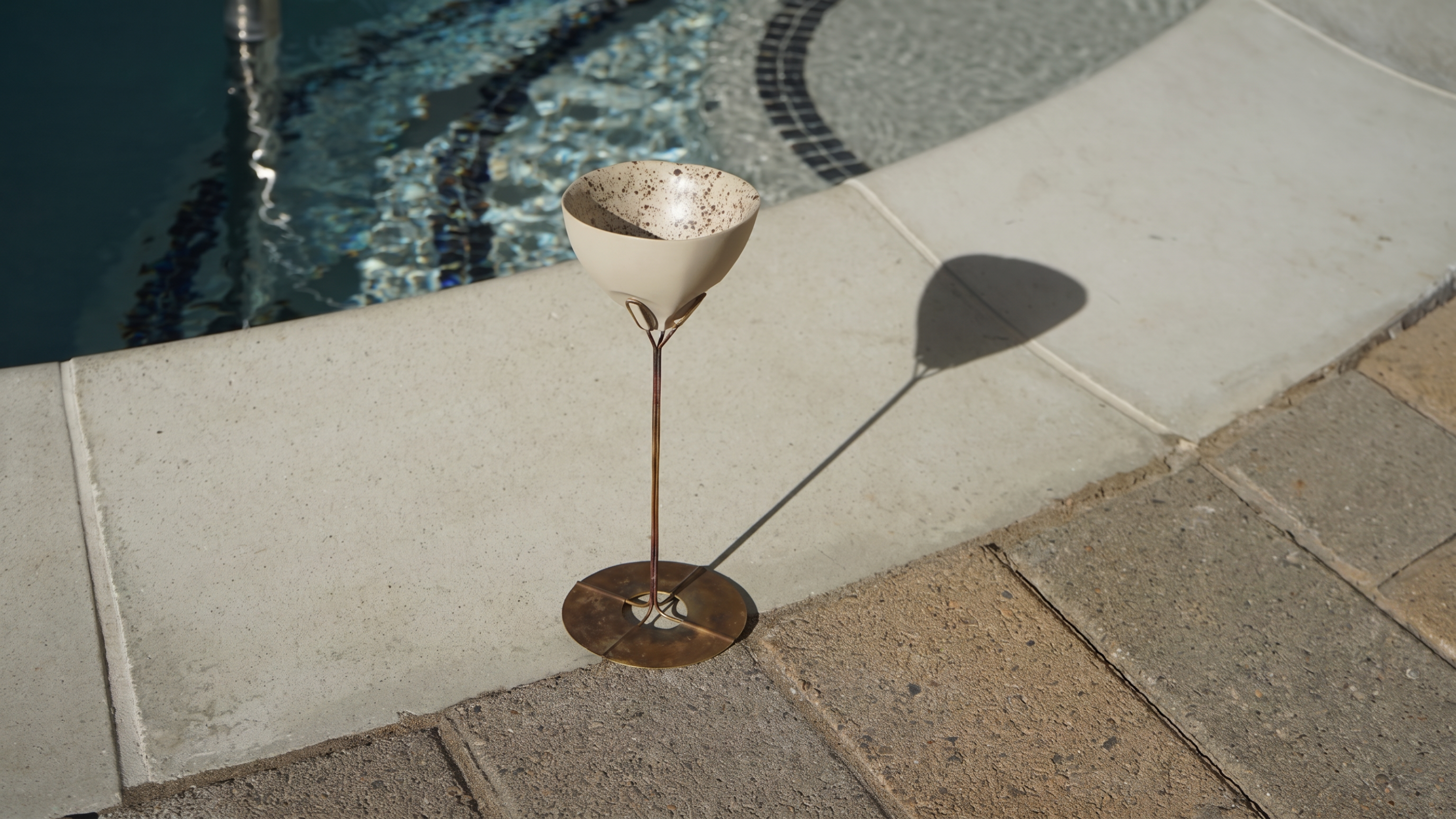 Ceramic cocktail vessel on a metal stand